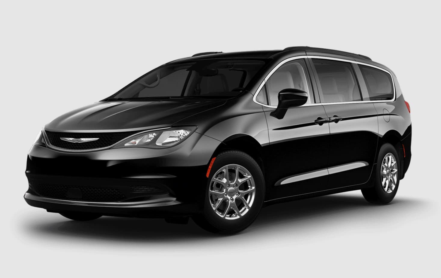 Manufacturer image of the base vehicle before conversion: a Chrysler Grand Caravan in black, front three-quarter view, with no ramp or lowered floor fitted