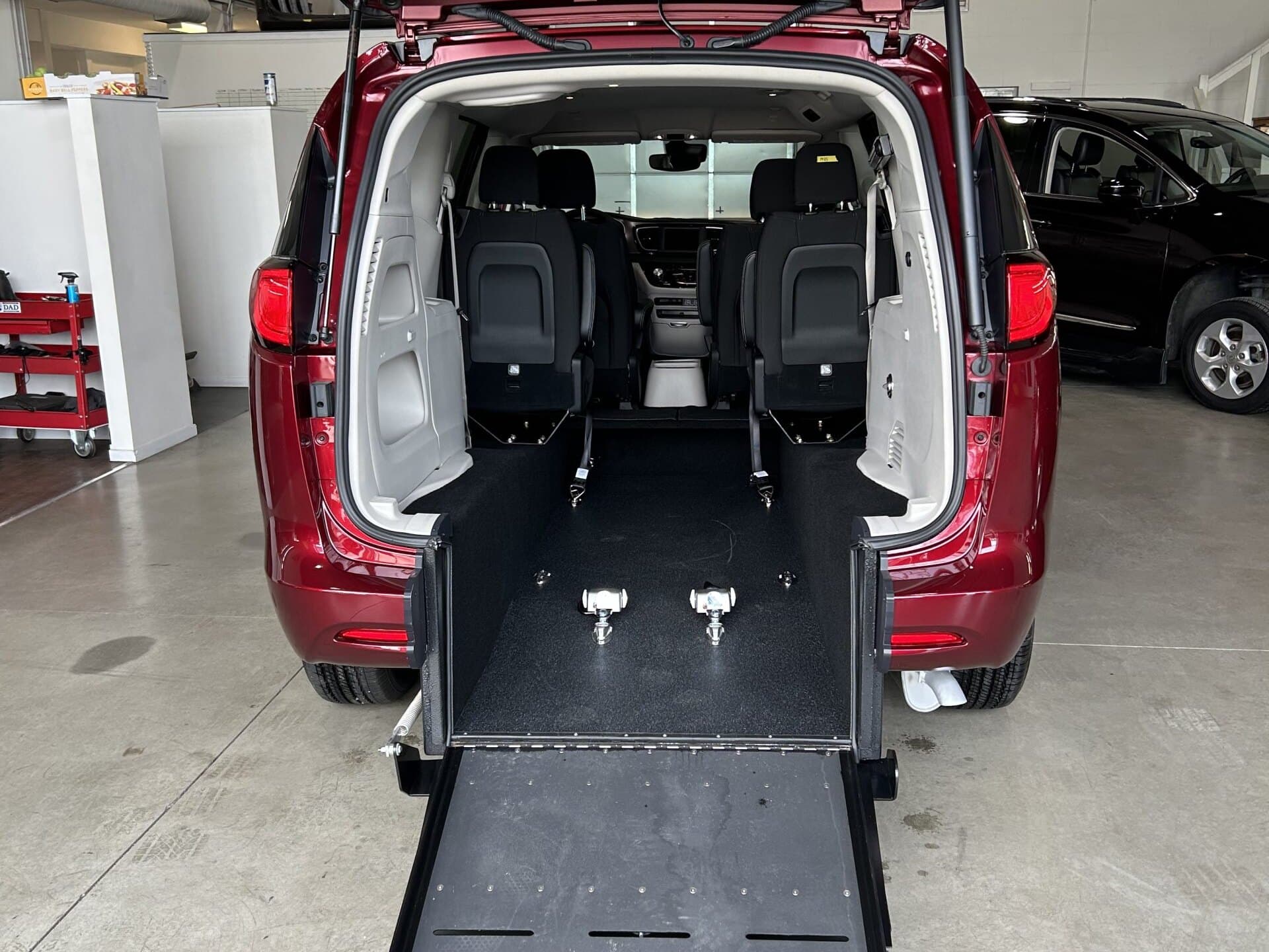 A Sidewinder rear-entry Chrysler conversion in the Chilliwack shop, ramp deployed from the lowered floor