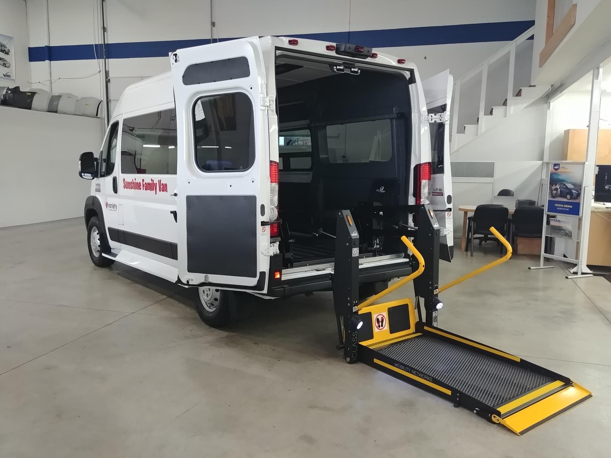 A full-size accessible van with a wheelchair lift in the Sidewinder service shop